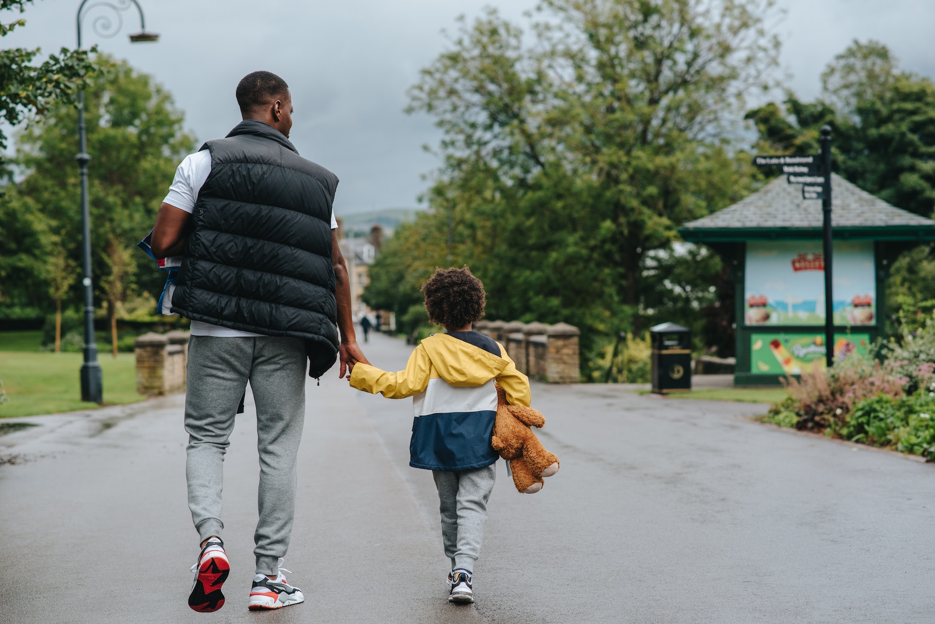 A father walks with his young child. LeSar Support Services partners with clients to create healthy and sustainable communities.